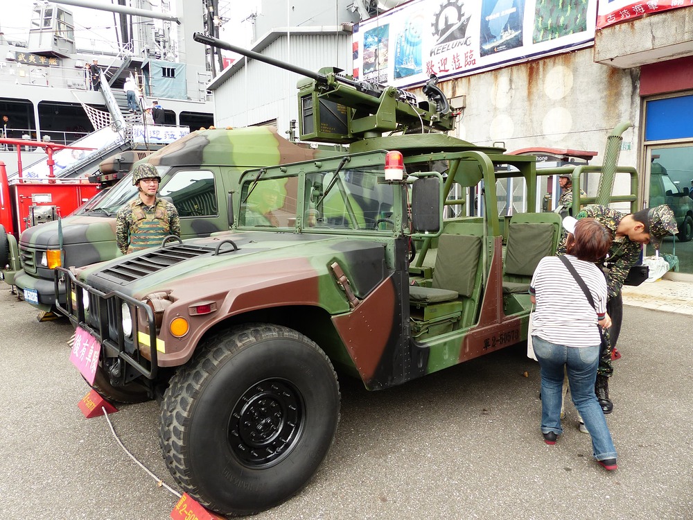 ROCMC_Petty_Officer_and_Mother_Help_Child_Climbing_up_Humvee_20140327