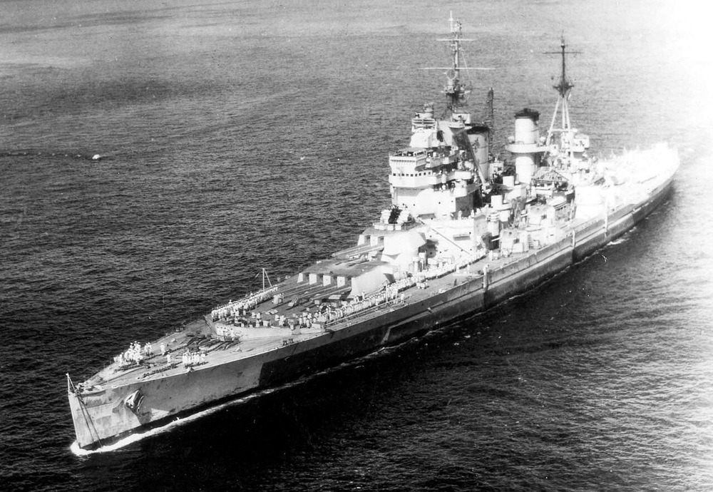 HMS King George V enters Apra Harbour, Guam with sailors on deck in 1945