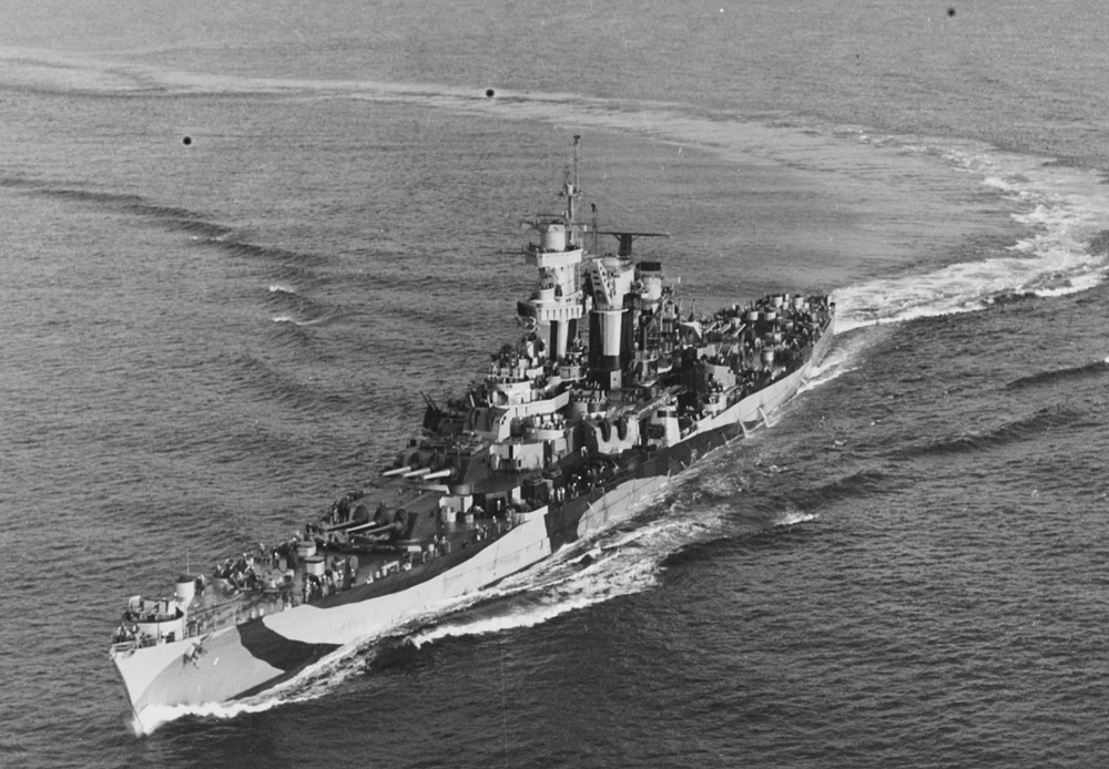 USS Guam (CB-2) coming out of a turn, circa 1944. She is painted in Camouflage Measure 32, Design 7C