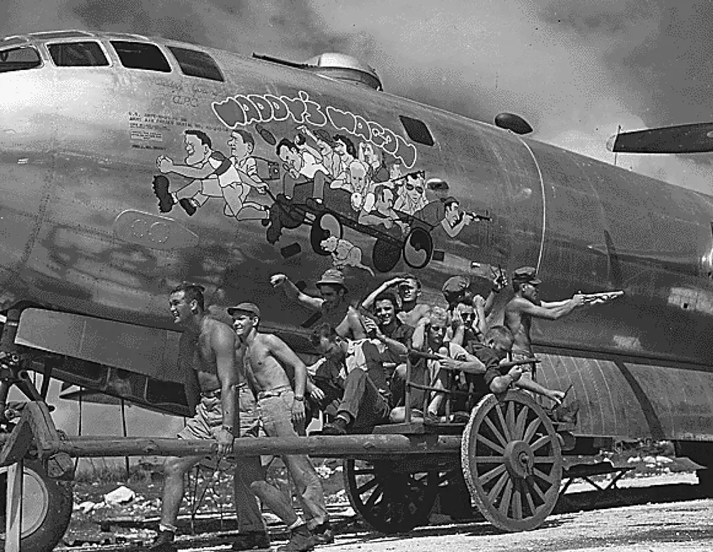 b-29-crew-members-posing-next-to-their-caricatures-1943-v0-wik0uzjdcegg1