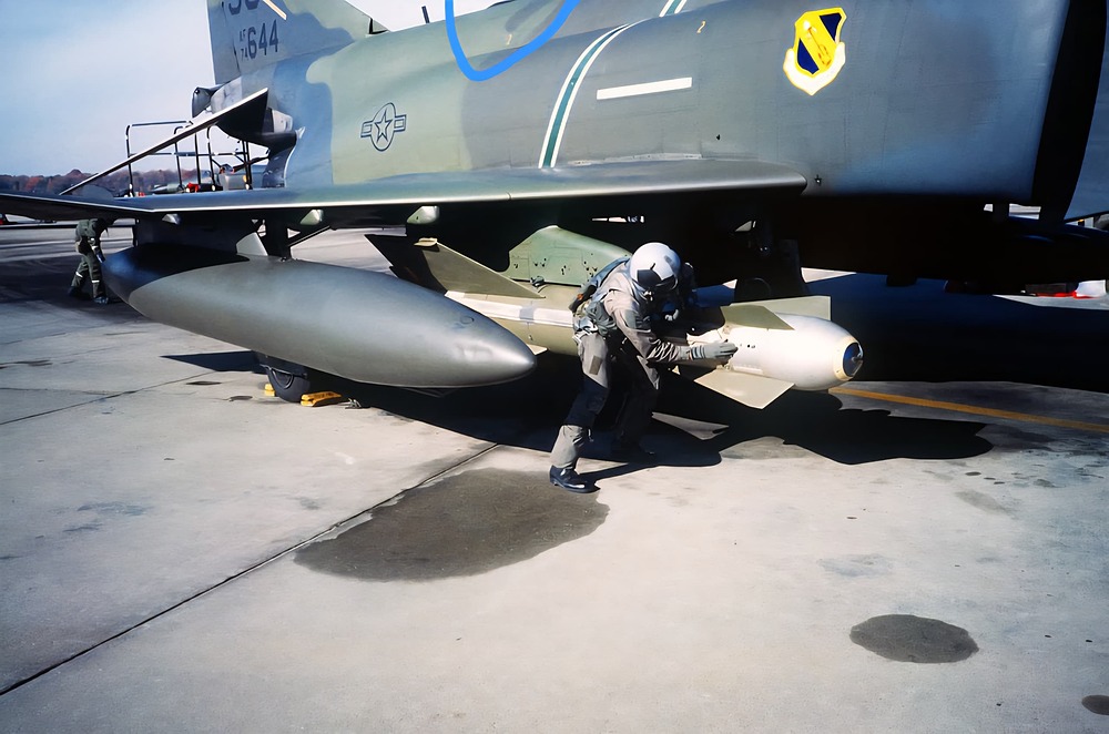 an-air-crewman-inspects-a-gbu-15-bomb-mounted-on-the-wing-of-an-f-4e-phantom-b67899-1024