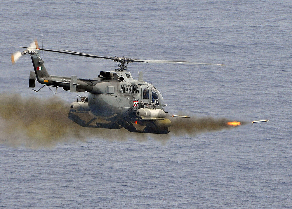 1280px-Mexican_BO-105_Bolkow_helicopter_fires_2.75_inch_high-explosive_rockets_at_the_ex-USS_Connolly_(DD_979)