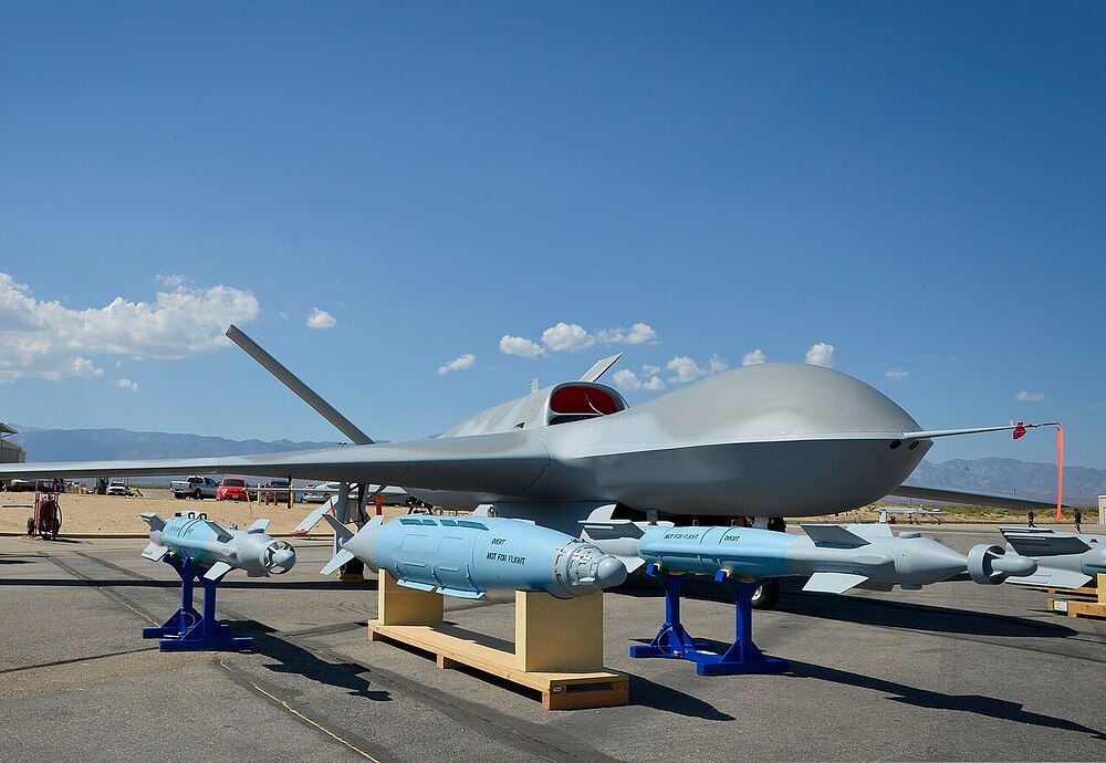 A_Predator_C_Avenger_unmanned_aircraft_system_and_inert_ordnance_sit_on_display_on_a_tarmac_at_Palmdale,_Calif.,_Aug._8,_2012_120808-N-WL435-054