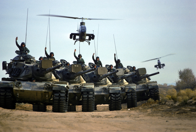 us-army-soldiers-give-hand-signals-from-m60-main-battle-tanks-during-a-field-0b84c7